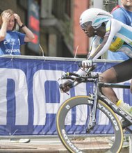 Jeanne D’arc Girubuntu of Team Rwanda races up Broad Street
on Tuesday during the Women’s Elite Individual Time Trial, making history as the first black woman to compete in the UCI Road World Championships. She is the lone female on the Rwandan team.