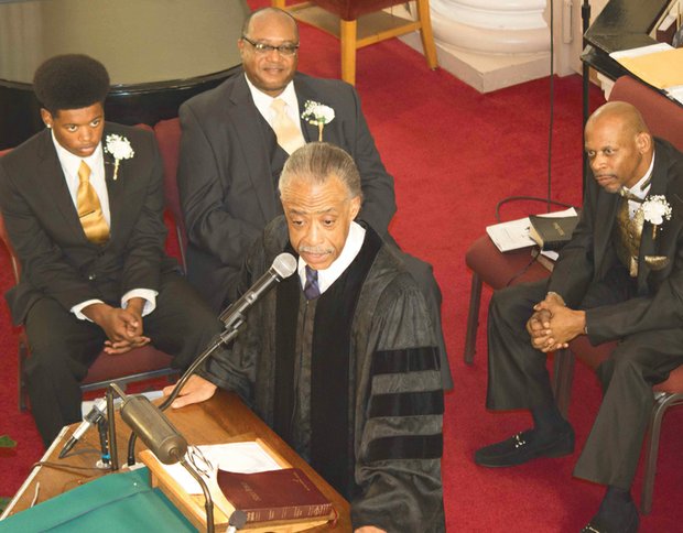 The Rev. Al Sharpton delivers the morning message at Gillfield Baptist Church in Petersburg on Sunday during its Men’s Day service, with Yonathan A. Seward, left, and Bob McNeil seated nearby.