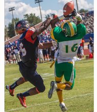 Virginia State University defensive back Malik Sexton, left, knocks away a pass intended for Kentucky State University receiver Bryan Henderson during last Saturday’s game at Rogers Stadium in Ettrick. The Trojans won 14-7.