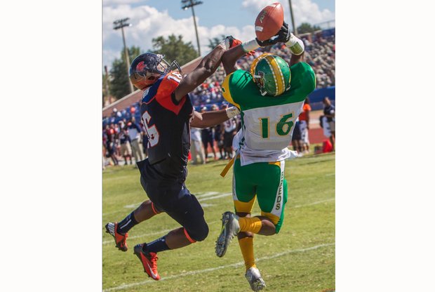 Virginia State University defensive back Malik Sexton, left, knocks away a pass intended for Kentucky State University receiver Bryan Henderson during last Saturday’s game at Rogers Stadium in Ettrick. The Trojans won 14-7.