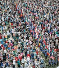 
Thousands of spectators packed Brown’s Island for the opening ceremonies of the UCI bike races, where students from Richmond Public Schools and surrounding counties carried flags representing the 74 participating countries.