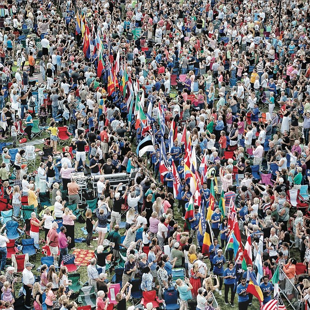 
Thousands of spectators packed Brown’s Island for the opening ceremonies of the UCI bike races, where students from Richmond Public Schools and surrounding counties carried flags representing the 74 participating countries.