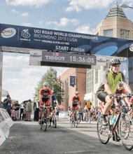 
Sen. Mark R. Warner, right, joins Team USA cyclists for a training ride last Friday through Downtown, hours before he appeared at the UCI Road World Championships opening ceremony on Brown’s Island.