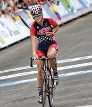 Chloe Dygert of Team USA proudly points to the letters on her jersey last Friday after finishing first in the Women’s Junior Road Race, earning her second gold medal in the competition.