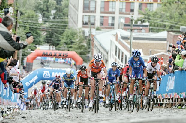 Cyclists make the grueling climb up the steep cobblestone hill Saturday on 23rd Street in the Women’s Elite Road Race.