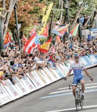 Peter Sagan of Slovakia triumphantly crosses the finish line at 5th and Broad streets Sunday as thousands of cheering, flag-waving, photo-taking fans acknowledge his win in the Men’s Elite Road Race to complete the 2015 UCI Road World Championships.