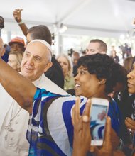 Cartrice Haynesworth takes a selfie with Pope Francis as he walks through the crowd during his visit last Thursday to Catholic Charities of the Archdiocese of Washington.