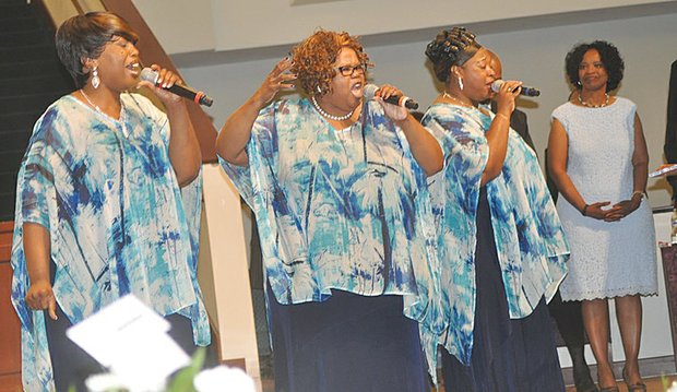 Members of The Ingramettes, from left, Minister Cheryl Maroney-Beaver, the Rev. Almeta Ingram-Miller and Valerie Stewart, sing at the funeral in June for group founder Maggie Ingram at St. Paul’s Baptist Church.