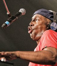 Hip-hop legend Grandmaster Flash delivers with energetic style, drawing a huge response, below, from enthusiastic fans.