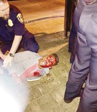 This photo taken by bystander Bryan Beaubrun shows the bloodied Martese Johnson as an officer holds down the University of Virginia honors student during his arrest March 18 outside a Charlottesville pub.   