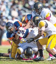 Virginia State University’s Trenton Cannon fights for extra yardage in the Trojans’ 22-19 homecoming game loss last Saturday to Bowie State University at Rogers Stadium.