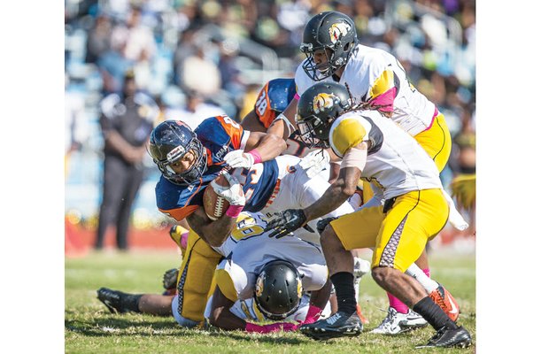 Virginia State University’s Trenton Cannon fights for extra yardage in the Trojans’ 22-19 homecoming game loss last Saturday to Bowie State University at Rogers Stadium.
