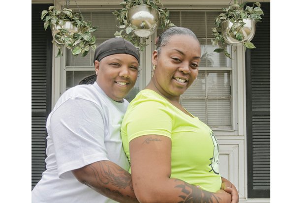 Shamika, left, and Kristea Fauntleroy affectionately embrace last week outside their Tappahannock home one year after Virginia legalized same-sex marriage, allowing the couple to exchange vows.