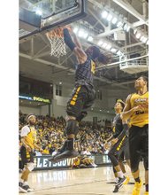 Junior Mo Alie-Cox dunks with authority during Virginia Commonwealth University’s fan-packed Black & Gold Game last Saturday at the Siegel Center. The Black Team won the scrimmage 85-76.