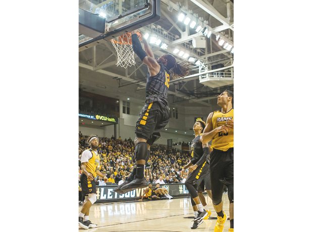 Junior Mo Alie-Cox dunks with authority during Virginia Commonwealth University’s fan-packed Black & Gold Game last Saturday at the Siegel Center. The Black Team won the scrimmage 85-76.