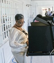 Sheila Anderson casts her ballot Tuesday at her polling place at Thirty-first Street Baptist Church in the East End.