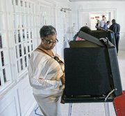 Sheila Anderson casts her ballot Tuesday at her polling place at Thirty-first Street Baptist Church in the East End.