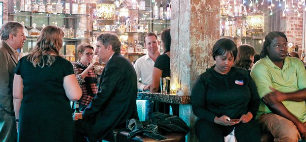 Democratic candidate Daniel H. Gecker, seated center, talks with supporters Tuesday night at a Shockoe Bottom restaurant while awaiting late election results from Powhatan County. With the county last and late to report, Mr. Gecker conceded the 10th Senate District race on Wednesday to Republican Glen H. Sturtevant Jr., a Richmond School Board member.