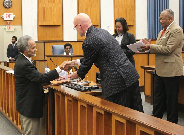 Maggie Walker advocate recognized /
Melvin S. Jones Jr., founder and president of the Maggie L. Walker Statue Foundation, accepts congratulations Monday from Richmond City Councilman Chris A. Hilbert, 3rd District, as Mayor Dwight C. Jones and Council President Michelle R. Mosby applaud his honor. Mr. Jones was recognized by council for his advocacy efforts since 2008 to erect a statue in the city for Mrs. Walker, the first African- American woman to establish and become president of a bank. As a result of his efforts, a monument commemorating Mrs. Walker is to be placed on a plaza at Broad and Adams streets in Downtown, with a target completion date of the fall of 2016. Also recognized Monday by council: Historic Mount Carmel Baptist Church at 3200 E. Broad St. in the East End, celebrating its 128th anniversary; and the Upsilon Omega Chapter of Alpha Kappa Alpha Sorority Inc., now marking its 90th anniversary.