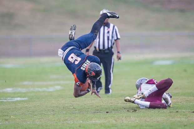 Virginia State University quarterback Tarian Ayres is upended by a Virginia Union University defender during Saturday’s 28-27 win by the Panthers over the host Trojans at Rogers Stadium in Ettrick. 