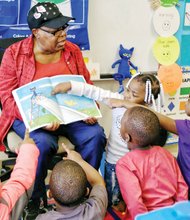 Where’s the cat?  //
Volunteer Inez Crews engages the attention and participation of pre-schoolers Tuesday at Dr. Martin Luther King Jr. Learning Center in the East End as she reads “Pete the Cat: Rocking in My School Shoes.” The book is part of the monthly read aloud and share program sponsored by RVA Reads. Each youngster will get a new book each month to take home and read and share with their families. Story on A6.