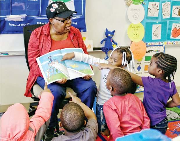 Where’s the cat?  //
Volunteer Inez Crews engages the attention and participation of pre-schoolers Tuesday at Dr. Martin Luther King Jr. Learning Center in the East End as she reads “Pete the Cat: Rocking in My School Shoes.” The book is part of the monthly read aloud and share program sponsored by RVA Reads. Each youngster will get a new book each month to take home and read and share with their families. Story on A6.