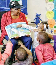 Where’s the cat? / Volunteer Inez Crews engages the attention and participation of pre-schoolers Tuesday at Dr. Martin Luther King Jr. Learning Center in the East End as she reads “Pete the Cat: Rocking in My School Shoes.” The book is part of the monthly read aloud and share program sponsored by RVA Reads. Each youngster will get a new book each month to take home and read and share with their families. Story on A6.