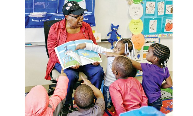 Where’s the cat? / Volunteer Inez Crews engages the attention and participation of pre-schoolers Tuesday at Dr. Martin Luther King Jr. Learning Center in the East End as she reads “Pete the Cat: Rocking in My School Shoes.” The book is part of the monthly read aloud and share program sponsored by RVA Reads. Each youngster will get a new book each month to take home and read and share with their families. Story on A6.