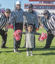 Are you ready for some football?
Three-year-old Mikenzie “Button” Williams recruits game officials for cheering duty last Saturday during halftime of the exciting Richmond Parks and Recreation Pee Wee Football championship game. The Battery Park Vikings defeated the Hotchkiss Eagles 6-0 in overtime, clinching the title for 9- and 10-year-olds at City Stadium. Championship matches also were played in four other age groups. Officials learning new cheers are, from left, William Jessie, Ellery Lundy, Rudy Waddell and Jimmy Drayton. 