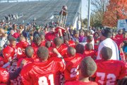 The Battery Park Vikings celebrate their 6-0 overtime victory to claim the Pee Wee Division trophy Saturday in the Richmond Parks and Recreation football championship at City Stadium.