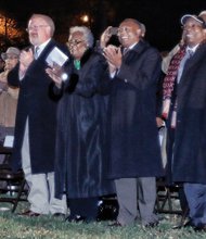 Above, Mayor Dwight C. Jones and Marilyn H. West, chair of the museum’s board, center, lead board members, other dignitaries and the public in applause as the lights go on. More than $8 million has been poured into transforming and expanding the former Leigh Street Armory for the museum’s use. The project is expected to be complete in January.