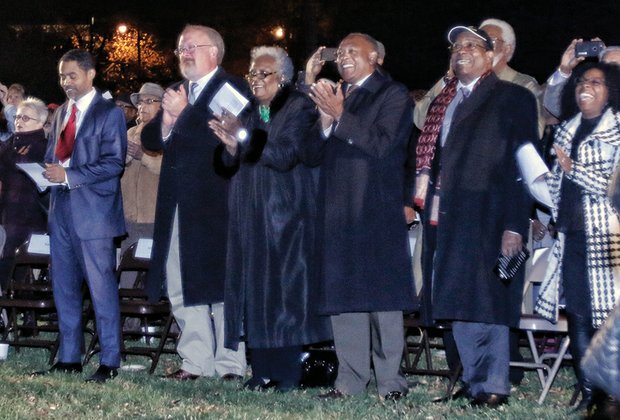 Above, Mayor Dwight C. Jones and Marilyn H. West, chair of the museum’s board, center, lead board members, other dignitaries and the public in applause as the lights go on. More than $8 million has been poured into transforming and expanding the former Leigh Street Armory for the museum’s use. The project is expected to be complete in January.