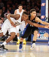 Virginia Commonwealth University guard Melvin Johnson, left, hustles past Duke University guard Derryck Thornton during the 2K Classic last Friday at Madison Square Garden in New York. Johnson scored 20 points but the Rams lost 79-71 to the Blue Devils.