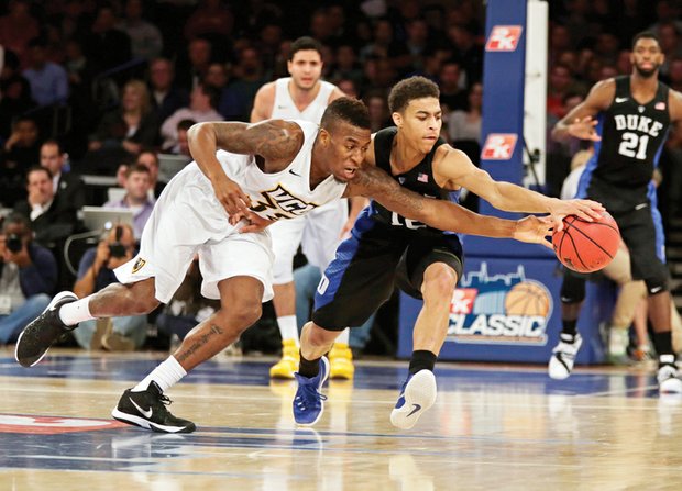 Virginia Commonwealth University guard Melvin Johnson, left, hustles past Duke University guard Derryck Thornton during the 2K Classic last Friday at Madison Square Garden in New York. Johnson scored 20 points but the Rams lost 79-71 to the Blue Devils.