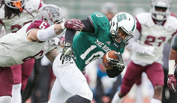 Virginia Union University linebacker Joshua Fasavalu, left, tries to get a grip on Slippery Rock University wide receiver Cornelius Raye during the Panthers’ first-round match last Saturday in the NCAA Division II football playoffs. The Panthers came up short 40-21.