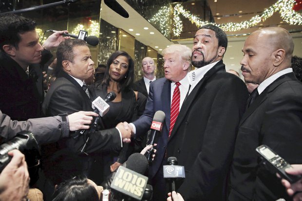 
Republican presidential front-runner Donald Trump is joined by a small group of pastors, including embattled Richmond Christian Center Senior Pastor Stephen A. Parson Sr., left, and Omarosa Manigault, a former contestant on Mr. Trump’s reality TV show “The Apprentice,” following Monday’s meeting at Trump Plaza in New York City.