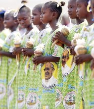 Children in the Central African Republic await the visit Monday of Pope Francis at a stadium in the capital, Bangui, where the pope led a Mass for thousands of people. 