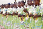 Children in the Central African Republic await the visit Monday of Pope Francis at a stadium in the capital, Bangui, where the pope led a Mass for thousands of people. 