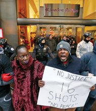 Demonstrators link arms in solidarity on Black Friday along Chicago’s Magnificent Mile shopping district to protest the 2014 police killing of teenager Laquan McDonald and the city’s handling of the case.  