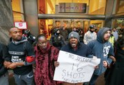 Demonstrators link arms in solidarity on Black Friday along Chicago’s Magnificent Mile shopping district to protest the 2014 police killing of teenager Laquan McDonald and the city’s handling of the case.  