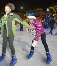 Brimming with excitement, Jessica Henderson, 14, reaches back to help Jordyn Henderson, 12, stay on her feet as the two skate at the city’s outdoor rink in the 600 block of East Broad Street in Downtown. They joined dozens of other skaters at last Friday’s opening ceremony for RVA On Ice, which debuted its sixth season with music, games, activities and prizes. American Idol finalist Rayvon Owen of Henrico County and the Richmond Boys Choir performed at the kickoff event that was hosted by Richmond Mayor Dwight C. Jones. The rink will be open for skating through Sunday, Jan. 3.