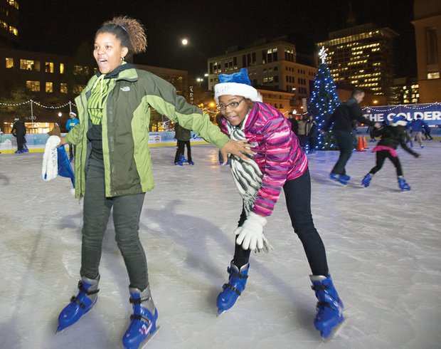 Brimming with excitement, Jessica Henderson, 14, reaches back to help Jordyn Henderson, 12, stay on her feet as the two skate at the city’s outdoor rink in the 600 block of East Broad Street in Downtown. They joined dozens of other skaters at last Friday’s opening ceremony for RVA On Ice, which debuted its sixth season with music, games, activities and prizes. American Idol finalist Rayvon Owen of Henrico County and the Richmond Boys Choir performed at the kickoff event that was hosted by Richmond Mayor Dwight C. Jones. The rink will be open for skating through Sunday, Jan. 3.