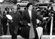 Rosa Parks arrives at the Montgomery, Ala., courthouse with supporters to be arraigned following her arrest Dec. 1, 1955, for refusing to move to the black section in the rear of a city bus. African-Americans then began a boycott of the bus company that lasted for more than a year.