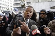 Pastor Stephen A. Parson Sr. of the Richmond Christian Center points to Donald Trump’s book, “Why We Want You to be Rich: Two Men, One Message,” co-authored with Robert Kiyosaki, as he talks to members of the media Monday in New York before the meeting of about 100 African-American ministers with the GOP candidate.