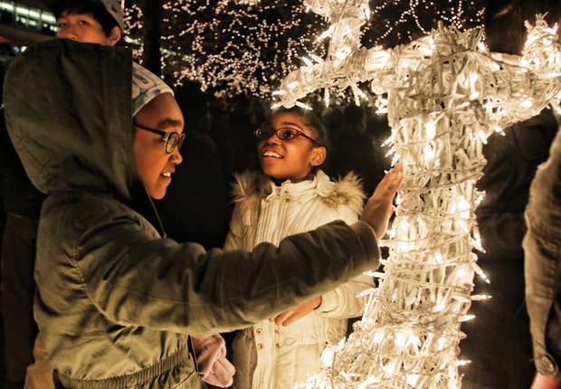 Devaney, left, and Andera Davis of Chesterfield County are wowed by a lighted reindeer on the holiday scape.