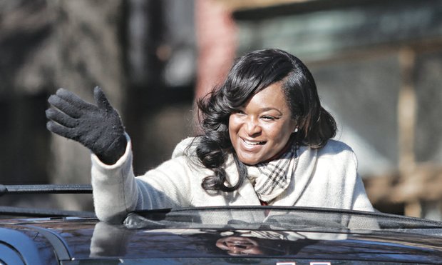 Holiday spirit on parade // Richmond City Council President Michelle R. Mosby, below, warmly waves to the crowd.