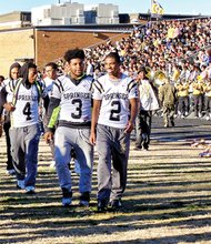 Springer players, from left, Greg Dortch, D.J. Anderson and Chris Thaxton lead teammates onto the field at Highland Springs High as cheerleaders and community members salute them as No. 1 in the state.