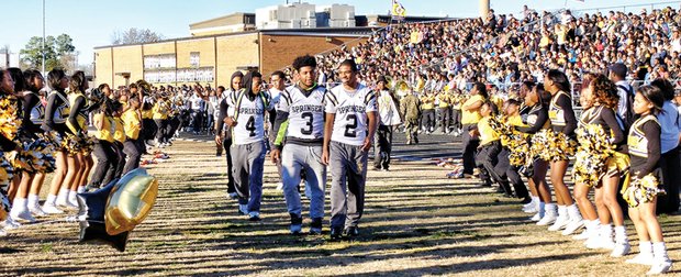 Springer players, from left, Greg Dortch, D.J. Anderson and Chris Thaxton lead teammates onto the field at Highland Springs High as cheerleaders and community members salute them as No. 1 in the state.