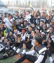 We’re No. 1! / Jubilant Highland Springs High School football team members and supporters show off their championship trophy after their 27-7 rout of Stone Bridge
High School of Loudoun County in the State Division 5 final last Saturday at the University of Virginia’s Scott Stadium in Charlottesville. The celebration continued Tuesday with a ceremony at the Henrico County school. 