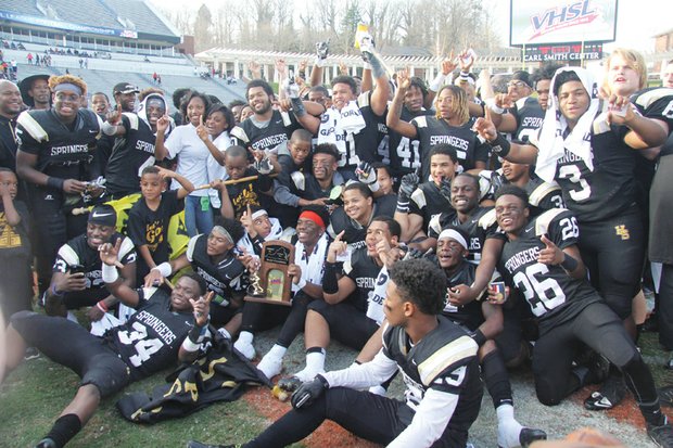 We’re No. 1! / Jubilant Highland Springs High School football team members and supporters show off their championship trophy after their 27-7 rout of Stone Bridge
High School of Loudoun County in the State Division 5 final last Saturday at the University of Virginia’s Scott Stadium in Charlottesville. The celebration continued Tuesday with a ceremony at the Henrico County school. 